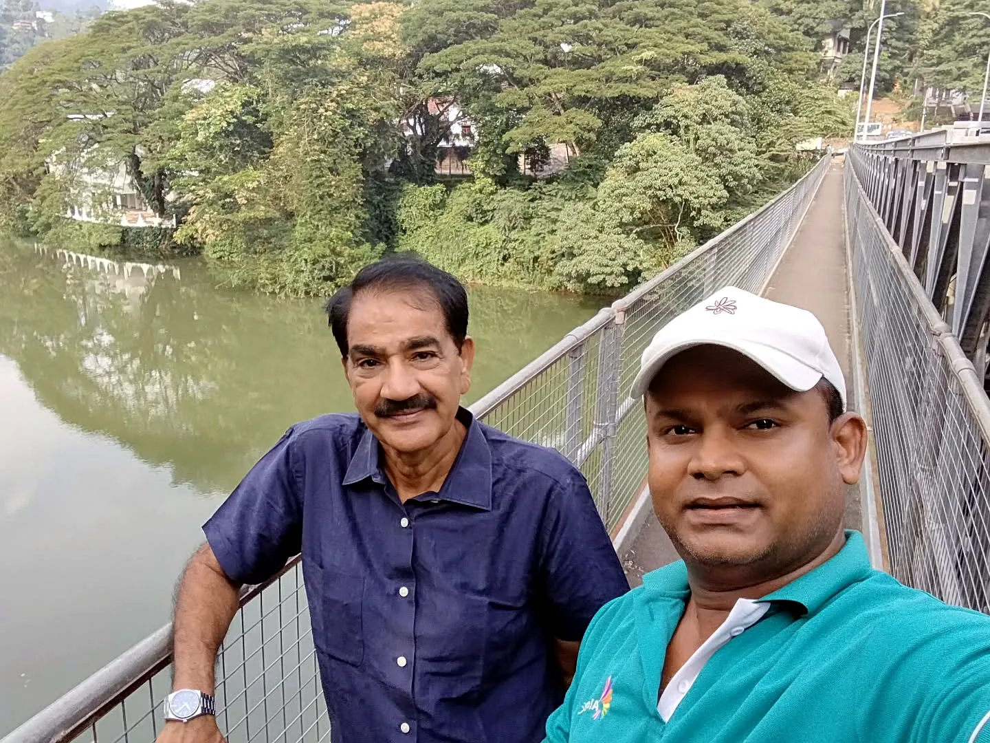 Thilak with a guest near a Kandy bridge
