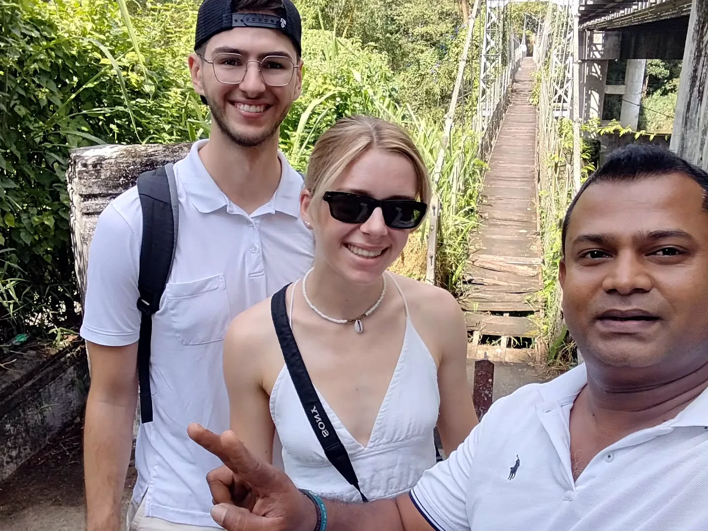 Thilak with guests near a Kandy suspension bridge